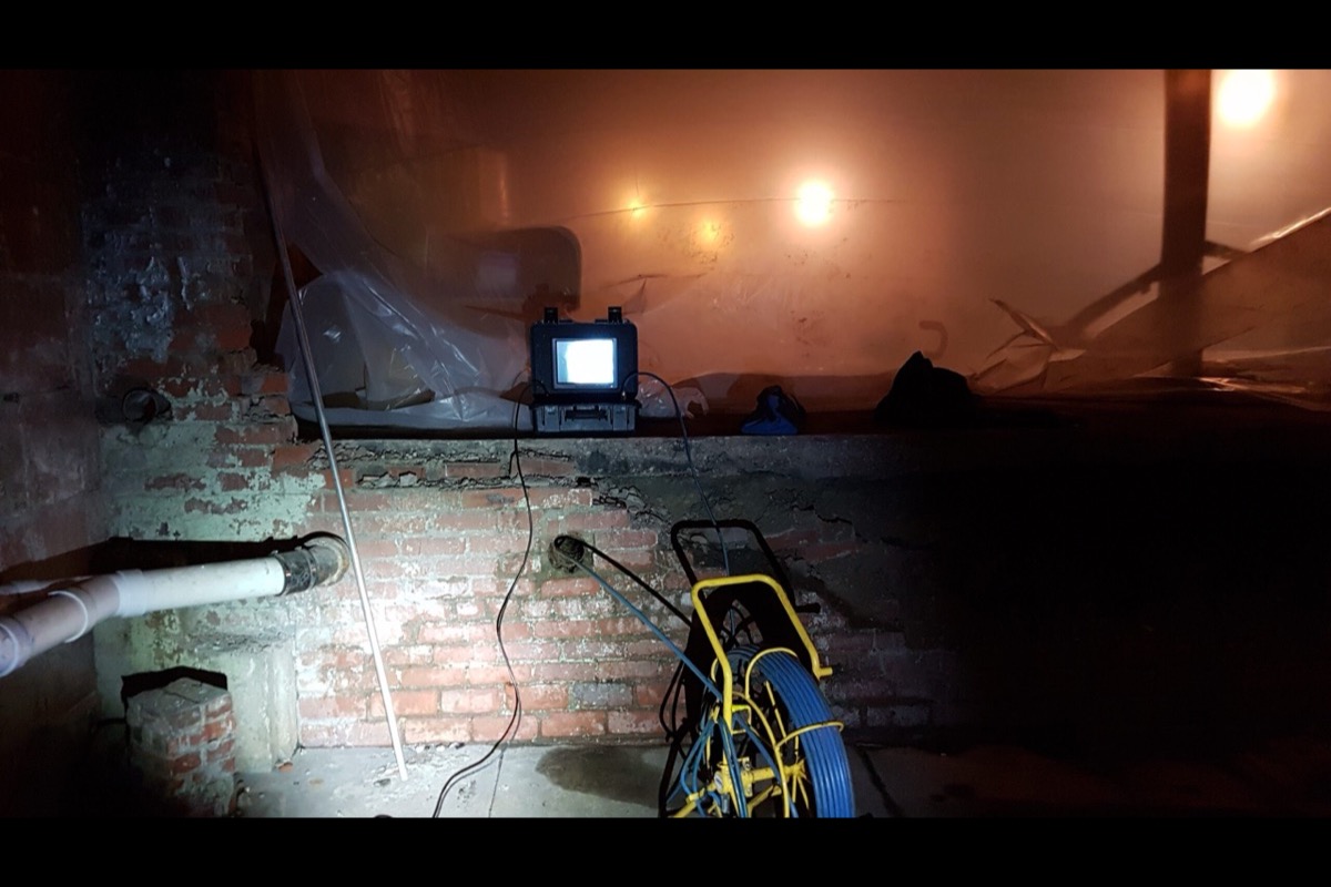 Sewer camera reel and monitor positioned inside near an accessible drain line